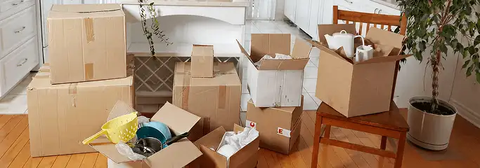 Packed moving boxes and household items in a kitchen before move-out or move-in cleaning, Nashua, NH.